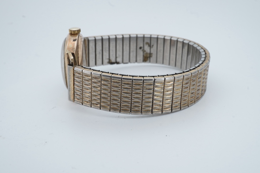 A 1930's 9ct gold Rolex manual wind wrist watch, with Arabic dial and subsidiary seconds, retailed by Grant & Son, Carlisle, on an associated gold plated flexible strap, case diameter 28mm (hand loose in dial). Condition